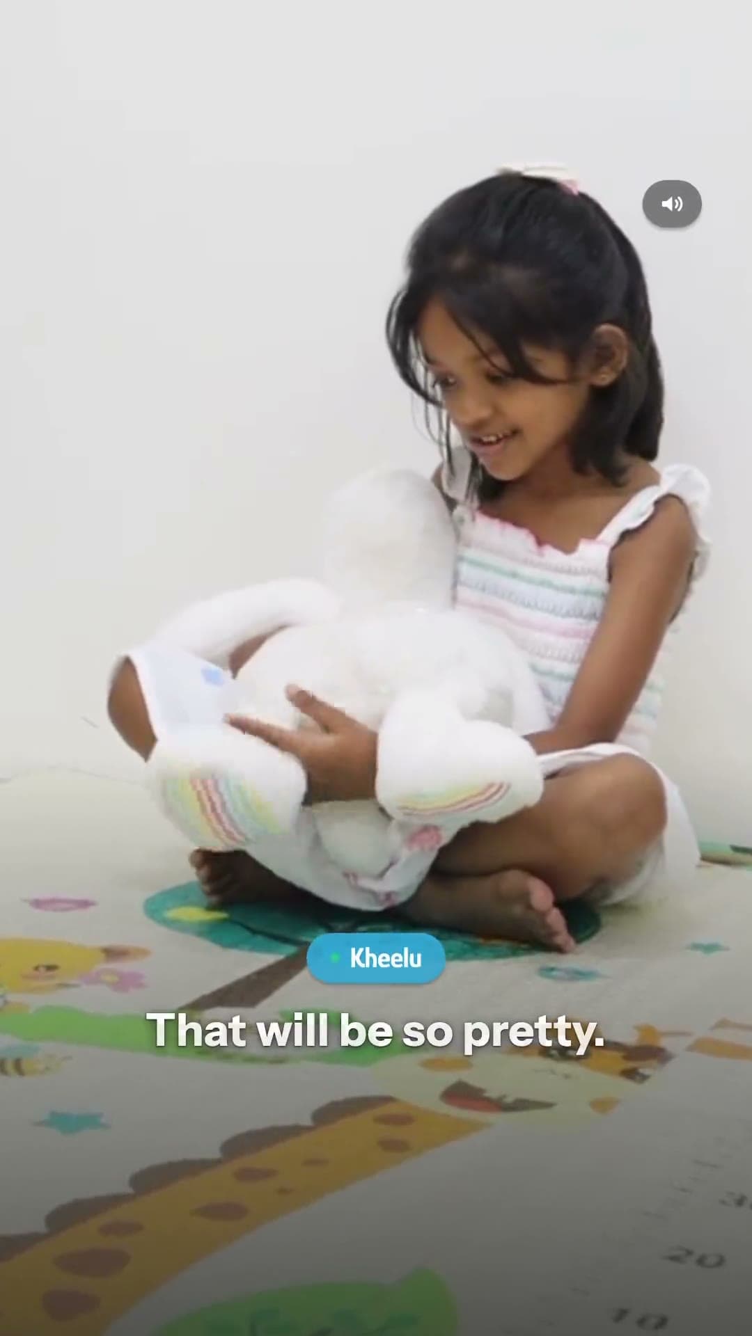 Children at home, talking to the cream Kheelu plush.